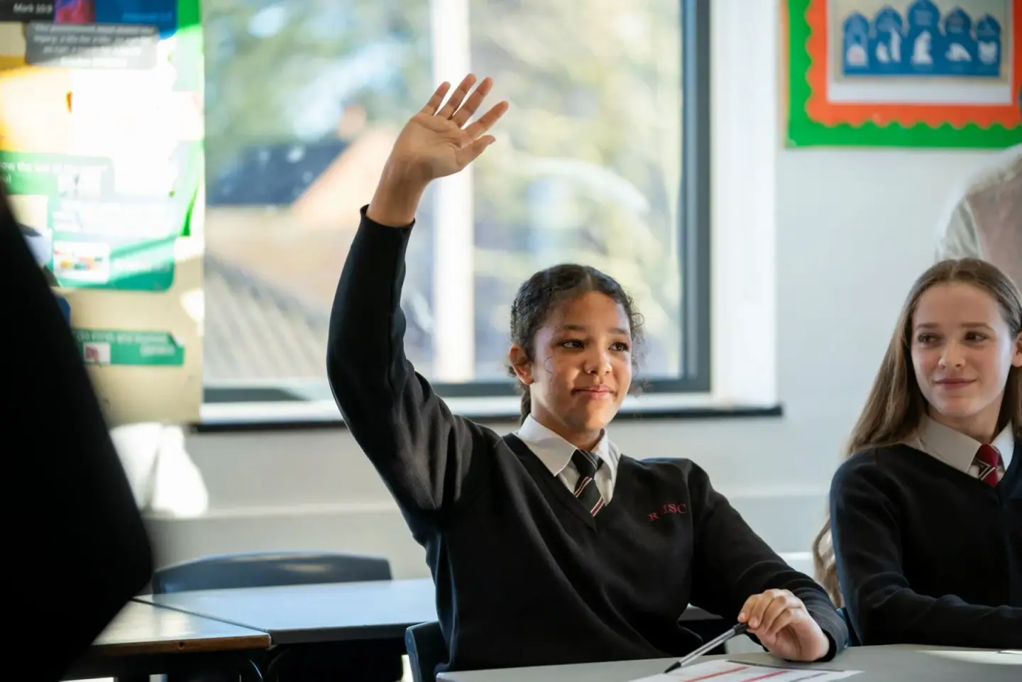 A pupil raising her hand in a Game Plan lesson, from the High Performance Foundation's own photography
