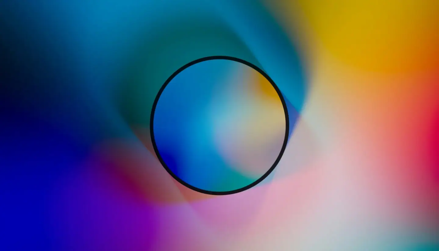 Abstract blurred multicolor background with a black circle in the center.