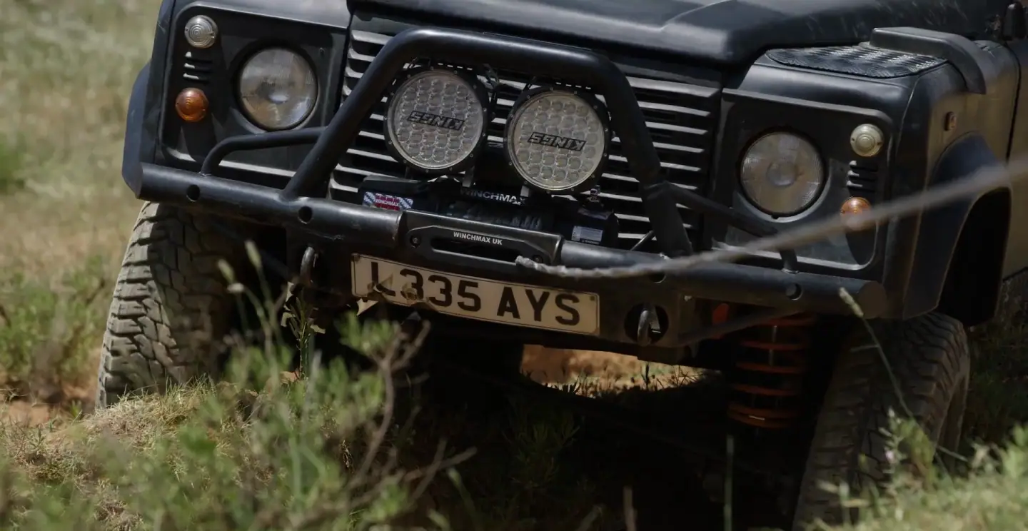 A Winchmax winch mounted on the bumper of a Land Rover Defender, off road, from Winchmax's own film