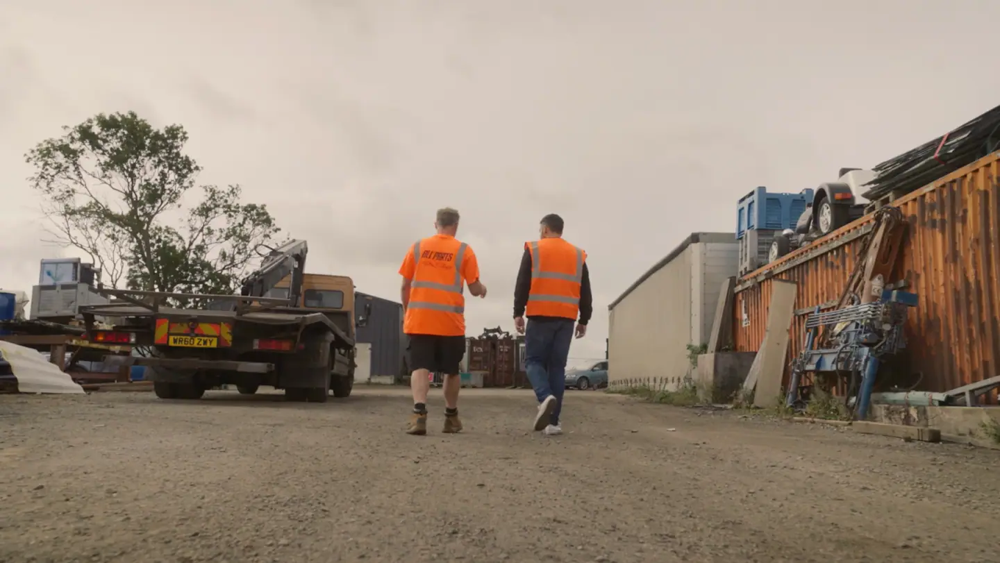 Tait Pollack and Luke Parfitt walking through the yard in hi-vis