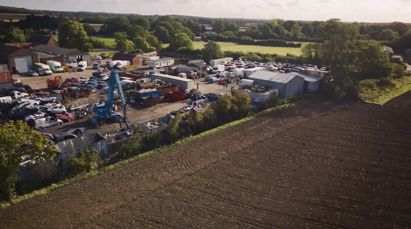 Aerial view of the yard in Hempnall, rows of vehicles beside open Norfolk fields