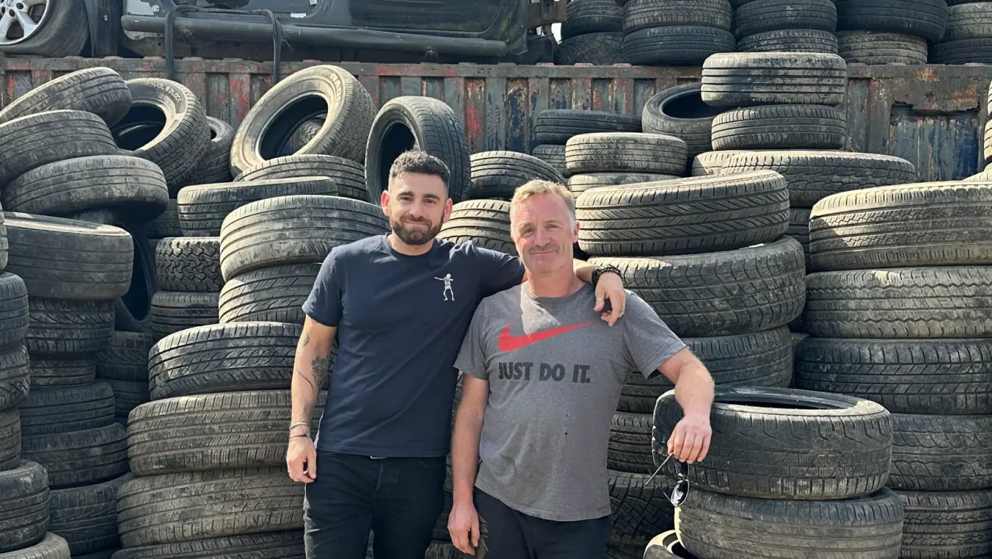 Tait Pollack, Pivotal's founder, and Luke Parfitt in front of the tyre stacks at Luke's yard in Hempnall